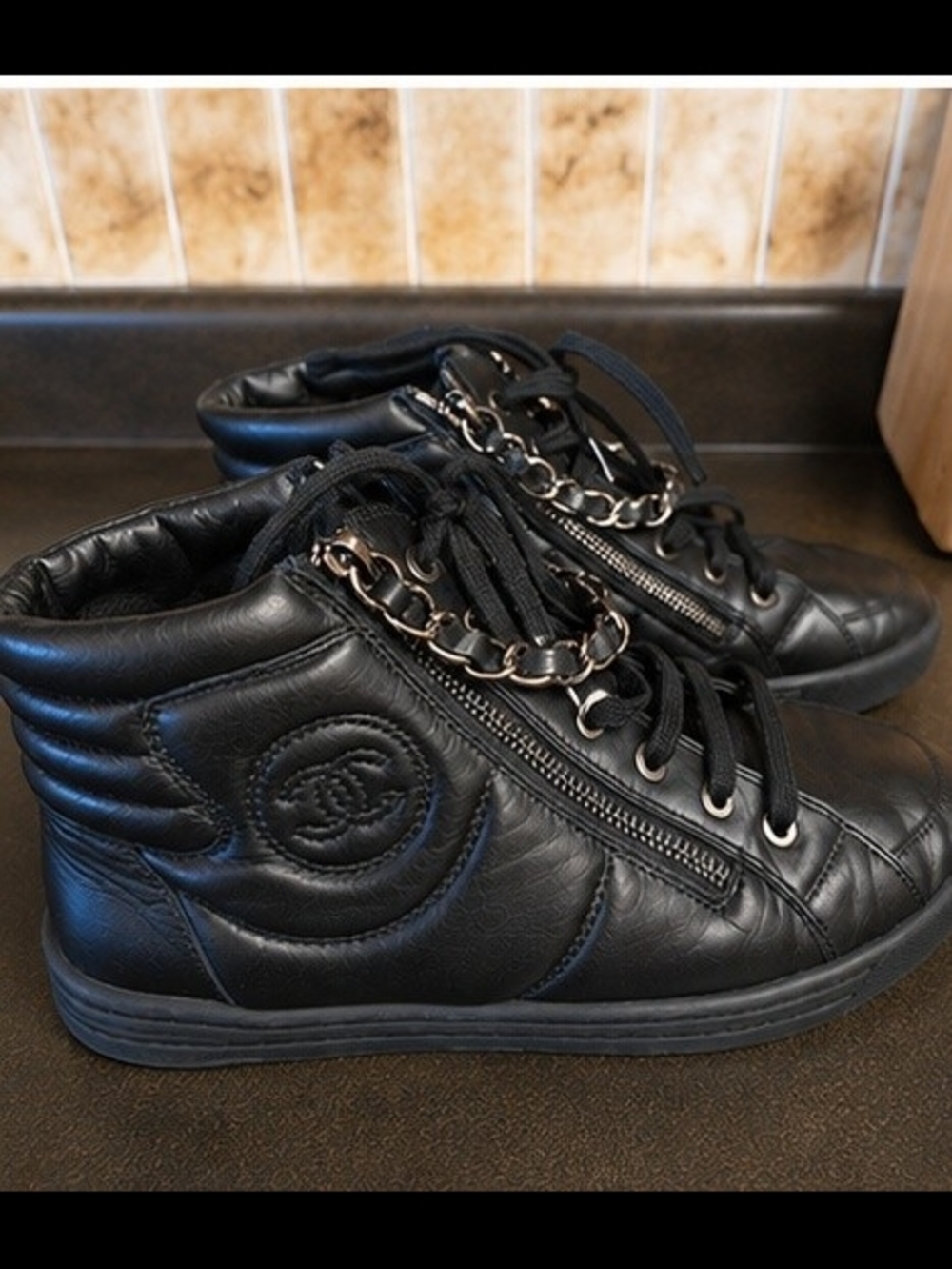 CHANEL Black Leather High-Top Sneakers with Chain Detail